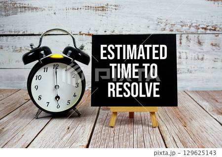 Estimated Time To Resolve text with easel and alarm clock on wooden background Estimated Time To Resolve text with easel and alarm clock on wooden background 129625143