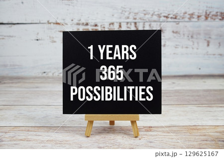 1 Year 365 Possibilities text with easel on wooden background 1 Year 365 Possibilities text with easel on wooden background 129625167