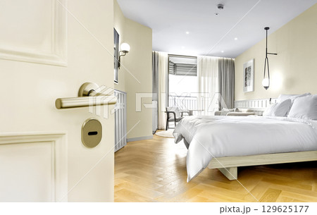 Opened White door of hotel room with bedroom background Opened White door of hotel room with bedroom background 129625177