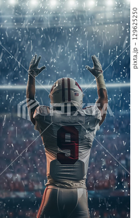 american football or rugby player man celebrating goal and raising hand at stadium, championship and winning concept 129625250