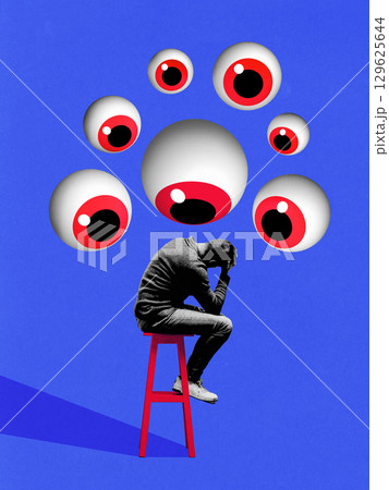 Surreal collage of man sitting on red stool under giant floating eyes with anxious posture on blue background Surreal collage of man sitting on red stool under giant floating eyes with anxious posture on blue background 129625644