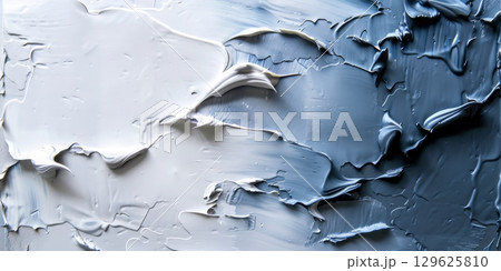 Palette knife painting creating textured white and blue abstract art 129625810