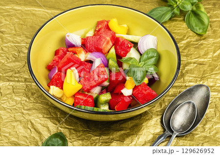 A fresh salad of watermelon cubes with cucumber slices. 129626952