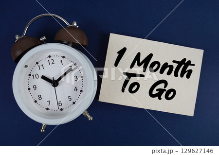 1 Month To Go text written on paper with alarm clock on blue background 1 Month To Go text written on paper with alarm clock on blue background 129627146
