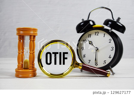 OTIF abbreviation of On Time In Full text with alarm clock on wooden background OTIF abbreviation of On Time In Full text with alarm clock on wooden background 129627177