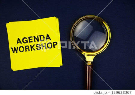Agenda Workshop text on sticky note with magnifying glass on navy blue background Agenda Workshop text on sticky note with magnifying glass on navy blue background 129628367