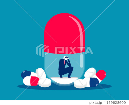 NO Drugs. Businessman sitting and sad inside big pil 129628600