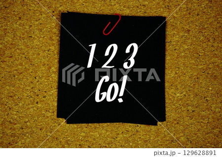 1 2 3 Go! text message on sticky note on cork paper background 1 2 3 Go! text message on sticky note on cork paper background 129628891