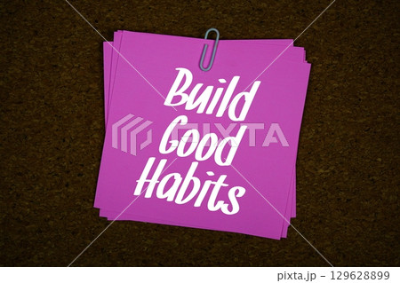 Build Good Habits text message on stick note on cork paper background Build Good Habits text message on stick note on cork paper background 129628899