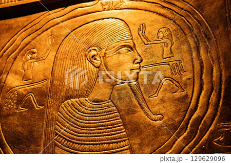 Pharaoh Depicted on Golden Wall in Ancient Egyptian Temple. Tutankhamun Pharaoh Depicted on Golden Wall in Ancient Egyptian Temple. Tutankhamun 129629096