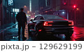 A police officer stands near patrol cars on a misty street at night, with blue and red lights reflecting on the wet road, creating a tense atmosphere of a potential crime scene 129629199