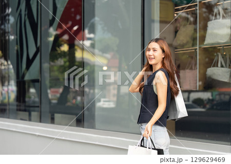 Black Friday shopping joy with woman outside retail store Black Friday shopping joy with woman outside retail store 129629469