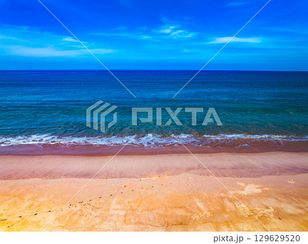 Aerial view of a sea surface water texture background and sun reflections Aerial flying drone view Waves water surface texture on sunny tropical ocean 129629520