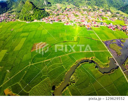Aerial top view of Green rice field at northern vietnam,Beautiful destination in Northern Vietnam,Travel and landscape concept, Nature and rice fields background Aerial top view of Green rice field at northern vietnam,Beautiful destination in Northern Vietnam,Travel and landscape concept, Nature and rice fields background 129629552