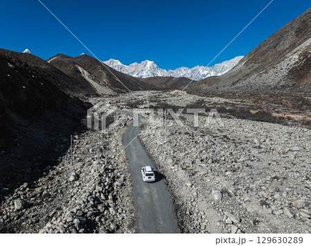 Driving off road car in high altitude mountains in tibet, China 129630289