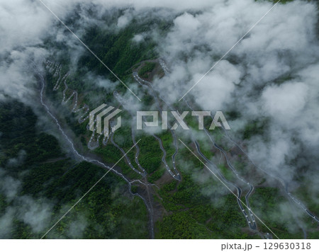 Aerial view of beautiful high altitude grassland mountain and winding road  landscape 129630318