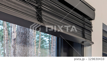 Motorized Wooden Blinds on Large Window in Pine Forest Home 129630410