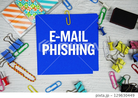 E-mail Phishing text on stick note with stationery on concrete background E-mail Phishing text on stick note with stationery on concrete background 129630449