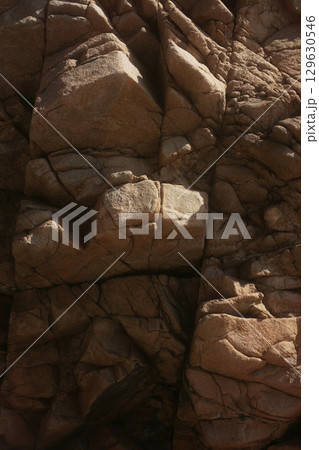 Textured Rock Formation with Unique and Distinctive Patterns and Features Embedded Within 129630546