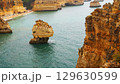 The coastal cliffs and stunning golden beach views create an unforgettable experience 129630599