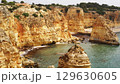 The coastal cliffs and stunning golden beach views create an unforgettable experience 129630605
