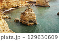 The coastal cliffs and stunning golden beach views create an unforgettable experience 129630609