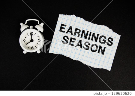 Earnings Season text written on paper with alarm clock on black background Earnings Season text written on paper with alarm clock on black background 129630620