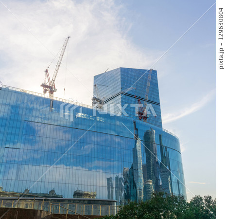 modern office building under construction in the blue sky background 129630804