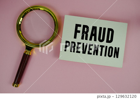 Fraud Prevention text written on paper with magnifying glass Fraud Prevention text written on paper with magnifying glass 129632120