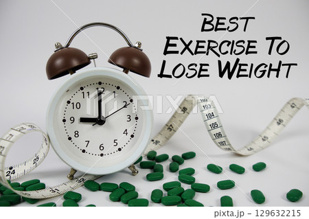 Best Exercise To Lose Weight text with medicine, alarm clock and measuring tape on white background 129632215