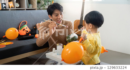 Creative Halloween Moments. Father and son crafting decorations. Creative Halloween Moments. Father and son crafting decorations. 129633224