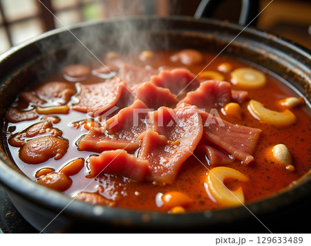Close-Up Authentic Chinese Hot Pot with Sliced Meat and Vegetables 129633489