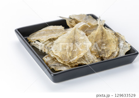 Dried sweet fish in a black plate. Scientific name is Parambassis siamensis. It is a type of food preservation. 129633529