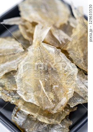 Dried sweet fish in a black plate. Scientific name is Parambassis siamensis. It is a type of food preservation. 129633530