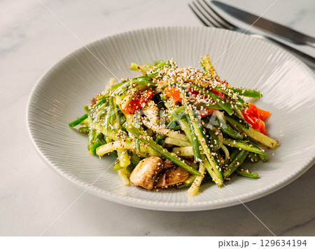 Delicious pork meat salad with cucumber in asian style with amaranth popcorn or popped amaranth (replaceable sesame). Idea salad recipe for healthy food menu. Vibrant bright pork salad with cucumber 129634194