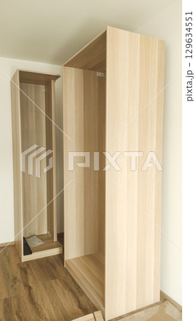 Assembling wooden wardrobe in modern apartment in prague 129634551