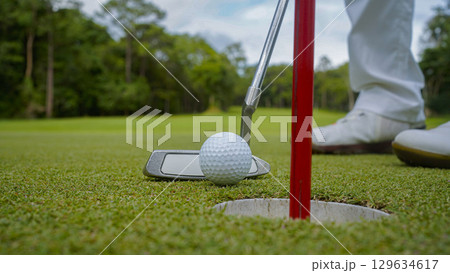 Golfers are playing golf in the evening golf course golf backglound. Golfers are playing golf in the evening golf course golf backglound. 129634617