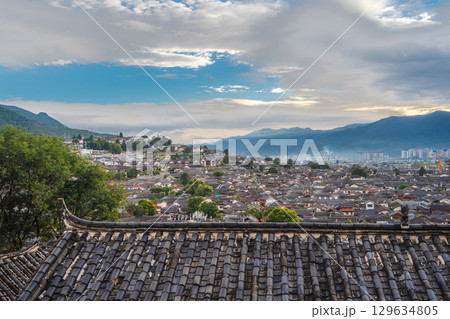 Overlooking Rooftops and Mountains from Lijiang Old Town, Yunnan, China 129634805