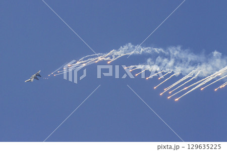 Sukhoi Su-30MK2 Fighter Of Vietnam People's Air Force Releases Flares On The Sky At The 50th Anniversary Of The Reunification Day. Sukhoi Su-30MK2 Fighter Of Vietnam People's Air Force Releases Flares On The Sky At The 50th Anniversary Of The Reunification Day. 129635225