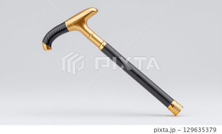 Elegant black-handled cane with gold accents on a plain background 129635379