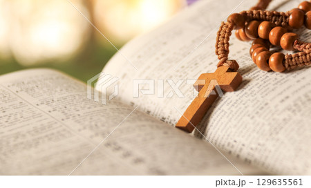 Wooden Jesus Cross on Old Book 129635561