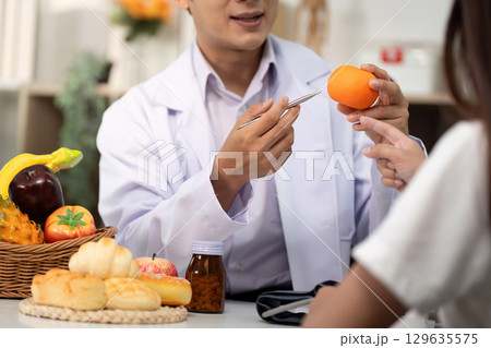 Nutrition Consultation. Health professional discussing healthy food choices with a patient. Nutrition Consultation. Health professional discussing healthy food choices with a patient. 129635575