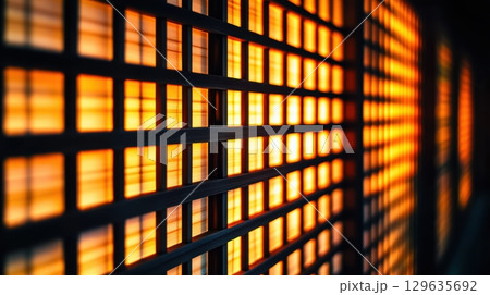 Warm light illuminating a grid panel in an urban environment during evening hours Warm light illuminating a grid panel in an urban environment during evening hours 129635692
