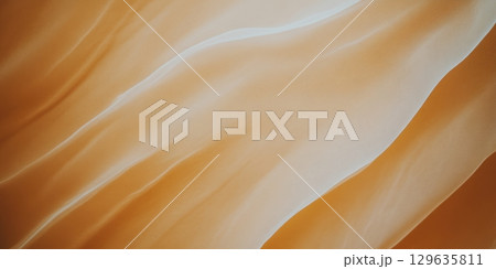 Warm hues of flowing waves capture the essence of natural beauty in sunlight 129635811