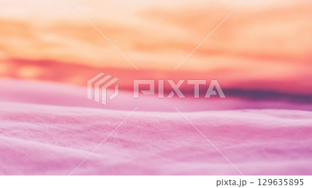 Soft pastel colors merge at dusk creating a serene and dreamy atmosphere on the landscape 129635895