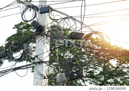 Image of tangled communication cables on poles Image of tangled communication cables on poles 129636099