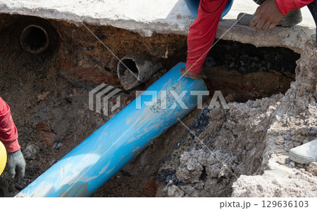 Workers are installing PVC pipes. Workers are installing PVC pipes. 129636103