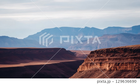 Dramatic landscape of canyons and mountains at dusk with shadows in a desert environment 129636690