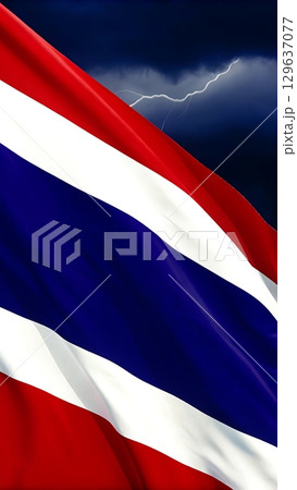 Waving thailand flag against a stormy sky with a flash of lightning seen 129637077