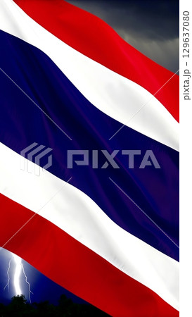 Waving thailand flag with lightning strikes in the background at nighttime 129637080